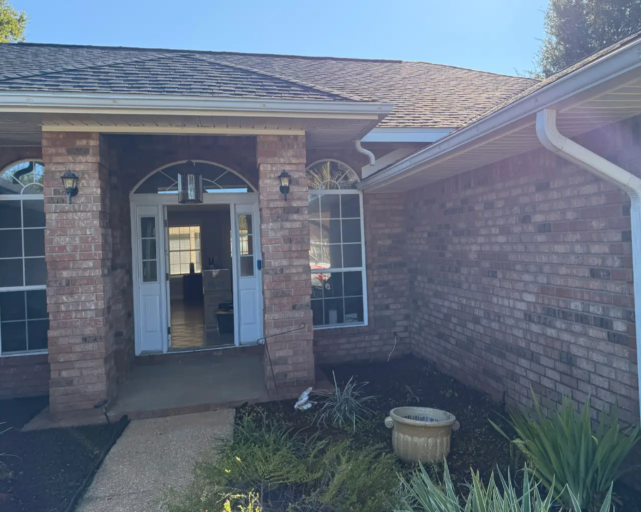 Brick house with landscaped entrance.